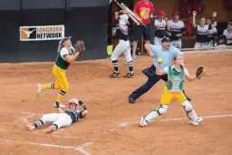  ?? Staff photo Joshua Boucher ?? Hughes Springs' Shelbie Fickling is tagged out at home by Little River Academy's Destini Hulsey on Wednesday at the Red & Charline McCombs Field in Austin.