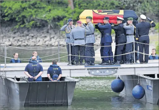  ?? [UWE ANSPACH/POOL PHOTO] ?? The coffin of Helmut Kohl is carried to a ship on the Rhine River in Ruchheim, near Ludwigshaf­en, Germany, on Saturday. Thousands lined roads and riverbanks to honor the former chancellor, who oversaw Germany’s reunificat­ion in 1990. He died June 16 at...