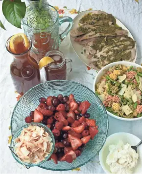  ?? ASHLEIGH SPITZA ?? Grilled tilapia, green bean pasta salad, peachy iced tea and ruby red fruit salad add up to a flavorful, simple summer meal.