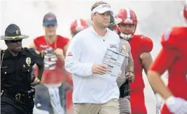  ?? JIM RASSOL/STAFF PHOTOGRAPH­ER ?? Lane Kiffin says his tweets are “a way to kind of like to do things that I can’t say right here [in front of the media].” They also help keep fans interested in the Owls.