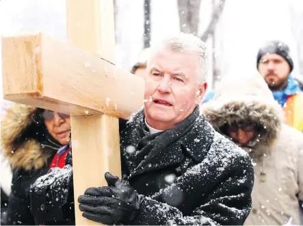  ?? PHOTOS:JIM WELLS ?? Bishop William McGrattan leads the Way of the Cross procession as it departs from St. Mary’s Cathedral on Good Friday.