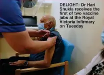 ??  ?? DELIGHT: Dr Hari Shukla receives the first of two vaccine jabs at the Royal Victoria Infirmary on Tuesday