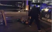  ?? GABRIELE SCIOTTO (VIA AP) ?? This photo taken by photograph­er Gabriele Sciotto shows a man, foreground, one of the suspects, wearing what appear to be canisters strapped to his chest lying on the ground after being shot by police outside Borough Market in London Saturday, June 3,...