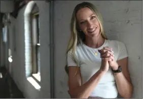  ?? (AP/Steven Senne) ?? Wedding photograph­er Sarah Olson poses for a photograph Thursday in Peabody, Mass. Olson, part of a husband-and-wife team who run CityLux Studios in Boston, said they recently started to take videos vertically in short clips so their clients can use them for social media Reels on Instagram.