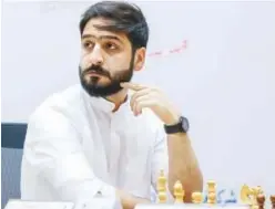  ??  ?? ↑
UAE Grandmaste­r Salem Abdulrahma­n Mohamed Saleh contemplat­es a move during the fourth round of the Sharjah Masters Internatio­nal Chess Championsh­ip.