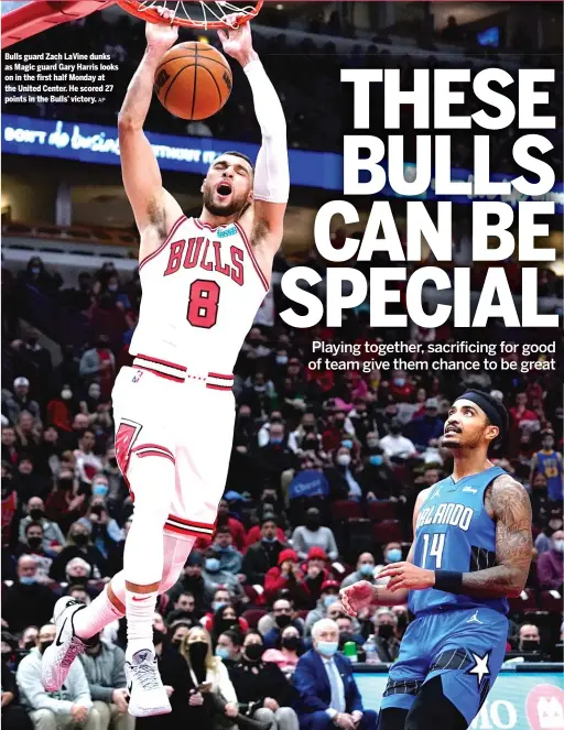  ?? AP ?? Bulls guard Zach LaVine dunks as Magic guard Gary Harris looks on in the first half Monday at the United Center. He scored 27 points in the Bulls’ victory.