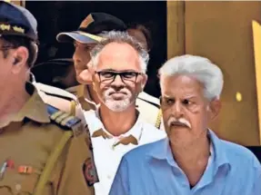  ??  ?? VARAVARA RAO and Sudhir Dhawale escorted by the police to a court hearing in Mumbai on February 28.