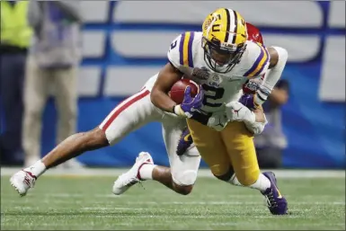  ?? JOHN BAZEMORE - THE ASSOCIATED PRESS ?? LSU wide receiver Justin Jefferson (2) runs against Oklahoma cornerback Woodi Washington (5) during the second half of the Peach Bowl NCAA semifinal college football playoff game, Saturday, Dec. 28, 2019, in Atlanta. LSU won 63-28.