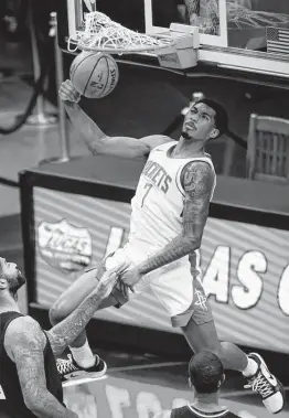  ?? Mark Mulligan / Staff photograph­er ?? Rockets guard Armoni Brooks dunks in two of his 15 points during the first quarter Friday. Brooks also was 3-of -7 from 3-point range.