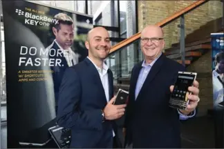  ?? RECORD STAFF ?? Matthew Kruschack, left, account vice-president with BlackBerry Mobile, and Bruce Walpole, the firm’s general manager, show off the new BlackBerry KeyOne phone on Thursday.