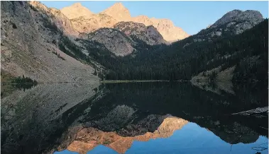  ?? — THE ASSOCIATED PRESS ?? Pika Peak is mirrored in Echo Lake, one of scores that dot the Absaroka-Beartooth Wilderness, making the region popular for hikers and anglers.