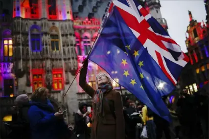  ?? Francisco Seco/Associated Press ?? A woman holds up the Union Jack and the European Union flags during an event Thursday to celebrate the friendship between Belgium and Britain at the Grand Place in Brussels.