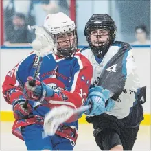  ??  ?? Justin McPherson of the Welland Generals tries to keep the ball away from Trent Hunter of the Niagara Thunderhaw­ks in junior B lacrosse action at the Meridian Credit Union Arena in Virgil.