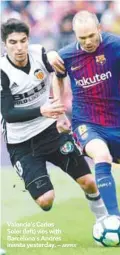  ?? AFPPIX ?? Valencia’s Carlos Soler (left) vies with Barcelona’s Andres Iniesta yesterday. –