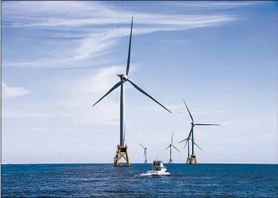  ?? The New York Times/CHANG W. LEE ?? Turbines at an offshore wind farm whirl near Block Island, R.I., last year.