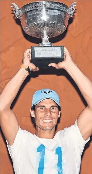  ??  ?? Rafael Nadal celebrates with the trophy after winning the French Open.