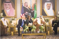  ?? STEPHEN CROWLEY/THE NEW YORK TIMES ?? President Donald Trump and King Salman, center right, have a brief tea ceremony Saturday at the King Khalid Airport in Riyadh, Saudi Arabia. Trump and the king spoke through an interprete­r, center, before the president and first lady Melania Trump,...