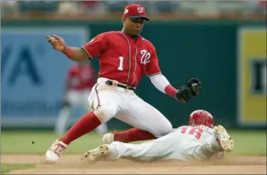  ?? NICK WASS — THE ASSOCIATED PRESS ?? Philadelph­ia Phillies’ Cesar Hernandez (16) steals second against Washington Nationals second baseman Wilmer Difo (1) during the seventh inning of a baseball game Saturday in Washington.