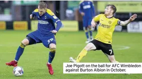  ??  ?? Joe Pigott on the ball for AFC Wimbledon against Burton Albion in October.