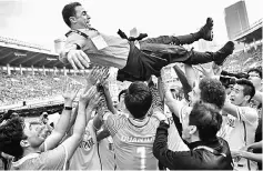  ??  ?? This file photo taken on Nov 4 shows players of Tianjin Quanjian throwing up their head coach Fabio Cannavaro as they celebrate their victory against Guangzhou Evergrande during the Chinese Super League (CSL) football league in Guangzhou, in China’s...