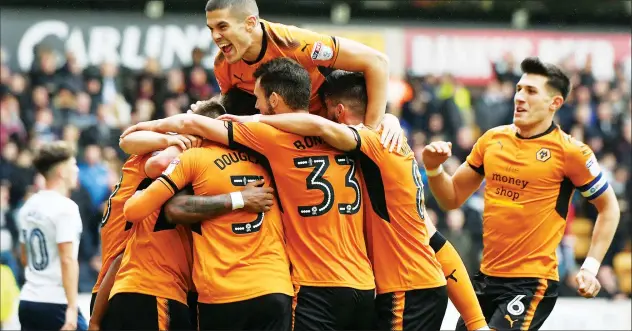  ?? PICTURES: Action Images ?? GROUP THERAPY: Wolves’ Ivan Cavaleiro is mobbed after scoring their first goal
