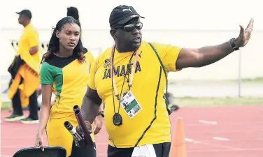  ?? FILE ?? Coach Paul Francis (right) makes a point to Stephenie-Ann McPherson during a training session at the Thomas A. Robinson Stadium warm-up track in Nassau, Bahamas, last April.