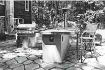  ?? TNS ?? An outdoor kitchen serves as the hub of the backyard experience.