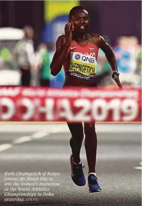  ?? EPA PIC ?? Ruth Chepngetic­h of Kenya crosses the finish line to win the women’s marathon at the World Athletics Championsh­ips in Doha yesterday.