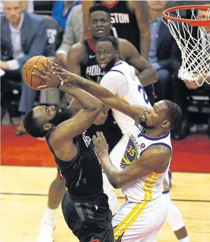  ??  ?? The Rockets’ James Harden, left, is fouled by the Warriors’ Kevin Durant in Game 2 in Houston.