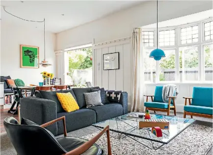  ??  ?? Christchur­ch homeowners Melanie and Jonathan Coote love mid-century furniture, such as these iconic blue Hans Wegner chairs.