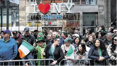  ?? Photo: Getty ?? People watch the St Patrick’s Day parade along New York City’s Fifth Avenue last year.