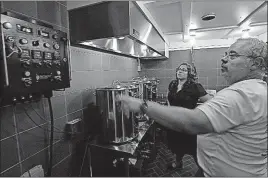  ?? [MORRY GASH/THE ASSOCIATED PRESS] ?? Steve Clemens and daughter Jillian working on a batch of beer in their home brewery in Lodi, Wisconsin.