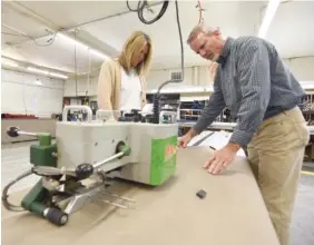  ??  ?? Co-owners Amy Clinton and Brent Songer weld material together at Tennessee Awning Co.