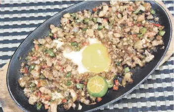  ?? SUNSTAR FILE ?? Made of chopped pig’s head and liver, sisig is a popular dish in many Filipino restaurant­s.FILIPINO FOOD BEYOND LECHON.