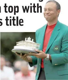  ??  ?? Tiger Woods of the United States celebrates with the Masters Trophy during the Green Jacket Ceremony after winning the Masters at Augusta National Golf Club in Augusta, Georgia. — AFP photo