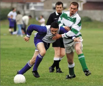  ??  ?? Christophe­r Lawless of Glenmuir is challenged by Alan Mackin of Shamrocks.