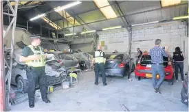  ??  ?? &gt; A police raid on a suspected ‘chop shop’ in the Midlands