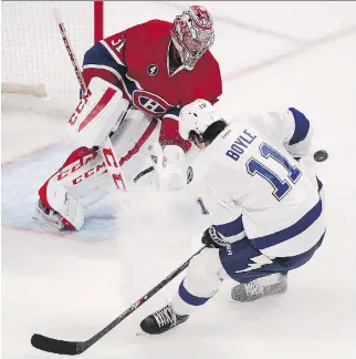  ?? P I E R R E O B E N D R AU F/ MO N T R E A L G A Z E T T E ?? Canadiens goalie Carey Price stops a shot by the Tampa Bay Lightning’s Brian Boyle at the Bell Centre on Monday night. Tampa won 5- 3.