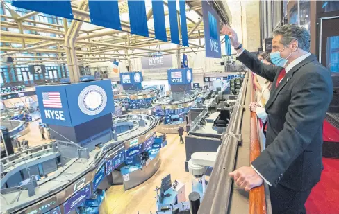  ?? CUOMO VIA REUTERS OFFICE OF GOVERNOR ANDREW M. ?? New York Governor Andrew Cuomo waves to traders after ringing the opening bell at the New York Stock Exchange (NYSE) on Tuesday.