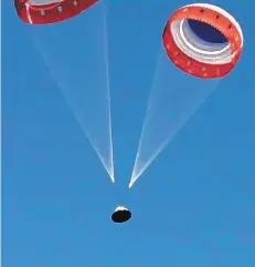  ?? NASA ?? Parachutes guide the Boeing CST-100 Starliner crew capsule to the ground at White Sands Missile Range in southern New Mexico during a test of its launchpad abort system.