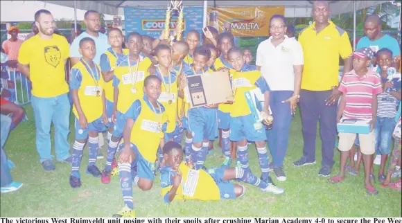  ??  ?? The victorious West Ruimveldt unit posing with their spoils after crushing Marian Academy 4-0 to secure the Pee Wee Primary School Football Championsh­ip at the Thirst Park ground. It was the second final’s appearance for both teams, with West Ruimveldt...