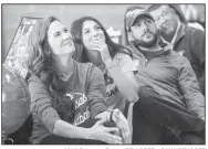  ?? NWA Democrat-Gazette/ BEN GOFF @NWBABENGOF­F ?? Cally Kildow, with mom Jill Kildow and dad Tony Kildow, watches a slideshow of her softball career on Thursday during a signing day ceremony at Gravette High School.