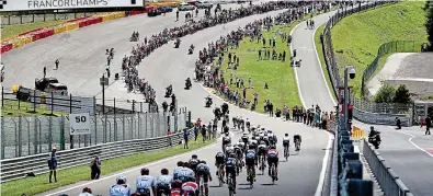  ??  ?? Power down: the peloton on the famous Eau Rouge bend at Spa’s motor racing circuit