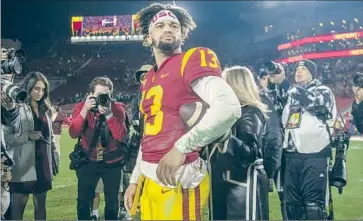  ?? Gina Ferazzi Los Angeles Times ?? CALEB WILLIAMS, pictured after USC beat Notre Dame on Nov. 26, is favored to win the Heisman Trophy.