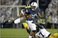  ?? CHRIS KNIGHT — ASSOCIATED PRESS ?? Penn State’s Saquon Barkley makes a move on Michigan’s Khaleke Hudson on Oct. 21 in State College, Pa.