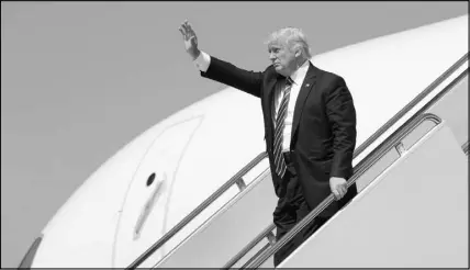 ?? SUSAN WALSH / AP ?? President Donald Trump waves Wednesday as he walks down the steps of Air Force One at Andrews Air Force Base in Maryland.