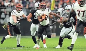  ?? ?? Bengals running back Joe Mixon had 30 carries for 123 yards and two touchdowns in a 32-13 win over the Raiders on Nov. 21.