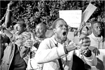  ??  ?? Protesters, some from Sub-Saharan African nations, shout slogans during a demonstrai­on against ‘Slavery in Libya’ outside the Libyan embassy in the Moroccan capital Rabat. — AFP photo