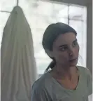  ?? BRET CURRY/A24 ?? In "A Ghost Story," the ghost of a man (Casey Affleck) watches his partner (Rooney Mara) grieve.