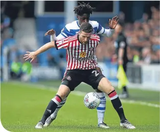  ??  ?? Sunderland’s Adam Matthews holds off QPR match-winner Ebere Eze